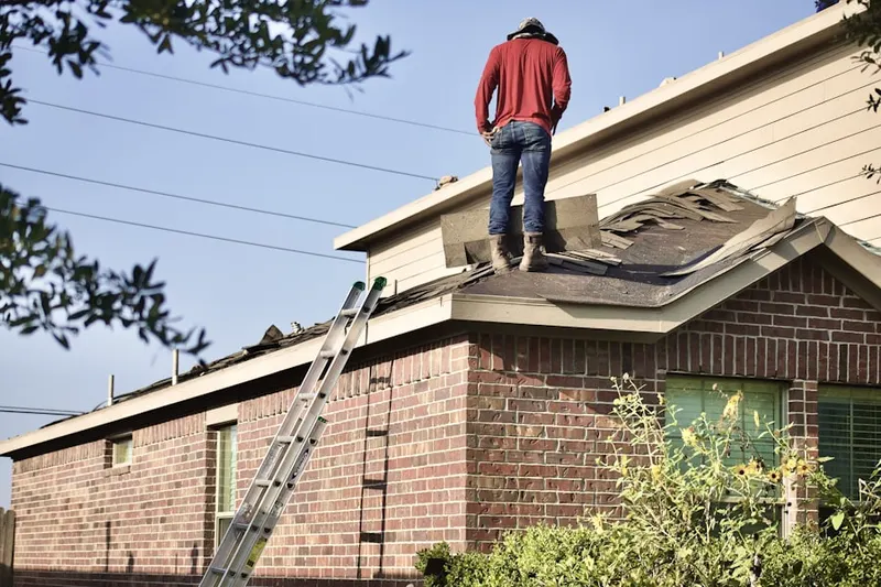 Professional roofer working on a residential roof in Saint Louis